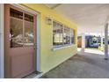 Covered front porch with light-colored door and window at 6005 Lords Ave, Sarasota, FL 34231