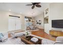 Living room with hardwood floors and a view into the dining area at 6600 Deering Cir, Sarasota, FL 34240