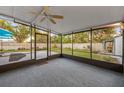 Spacious screened porch with grey carpeting and ceiling fan at 6915 11Th Nw Ave, Bradenton, FL 34209