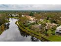House nestled on a waterfront lot with mature trees at 7117 Victoria Circle, University Park, FL 34201