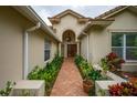 Elegant entryway with double doors and brick walkway at 7117 Victoria Circle, University Park, FL 34201