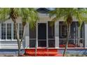 Inviting screened porch with red floor and wrought iron railings at 1111 24Th W St, Bradenton, FL 34205