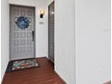 Gray front door with a blue wreath and welcome mat, along with modern house numbers at 2045 Gulf Of Mexico Dr # M1-502, Longboat Key, FL 34228