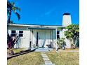 Front view of a white house with a black door and walkway at 222 27Th W St, Bradenton, FL 34205