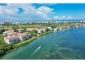 Breathtaking aerial view of waterfront condos and lush landscaping against a stunning coastal backdrop at 350 Gulf Of Mexico Dr # 211, Longboat Key, FL 34228