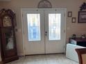 Front entrance with white double doors and glass panels at 5630 3Rd W St, Bradenton, FL 34207