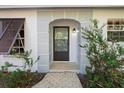 House entrance with arched entryway and brown door at 608 N Jefferson Ave # 30, Sarasota, FL 34237