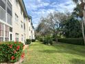 Landscaped grounds with lush greenery alongside the condo building at 7301 29Th Avenue W Dr # 206, Bradenton, FL 34209