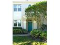 Inviting teal front door adds a pop of color to this charming home's facade at 7404 Botanica Pkwy # 102, Sarasota, FL 34238