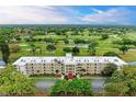 Aerial view of condo building showcasing a lush golf course backdrop at 7461 W Country Club Dr. N N # 106, Sarasota, FL 34243