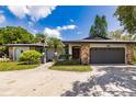 House exterior featuring a stone facade and a two-car garage at 7707 10Th Nw Ave, Bradenton, FL 34209