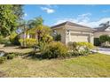 Single-story house with a two-car garage, and lush landscaping at 11634 Piedmont Park Xing, Bradenton, FL 34211