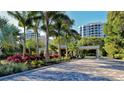 Gated community entrance with lush landscaping at 1211 Gulf Of Mexico Dr # 108, Longboat Key, FL 34228