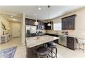 Modern kitchen with granite countertops, a large island with bar seating, and stainless steel appliances at 1387 Still River Dr, Venice, FL 34293