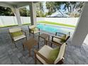 Relaxing outdoor space with comfortable seating, perfect for enjoying the poolside view and outdoor entertaining at 1859 Lamont St, North Port, FL 34288