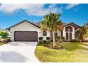 Well-maintained house with a palm tree and a driveway at 301 Gold Tree, Punta Gorda, FL 33955