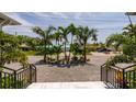 View from the front porch of a home looking down a street with palm trees at 609 Dundee Ln, Holmes Beach, FL 34217