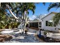 Spacious backyard with palm trees, a hammock, and a flagstone patio at 633 Calle De Peru, Sarasota, FL 34242