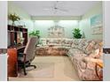 Home office featuring a large sectional sofa and a workspace at 6908 Drewrys Blf # 711, Bradenton, FL 34203