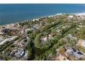 An aerial view of a property near the beach in a residential area at 7263 Plovers Way, Sarasota, FL 34242