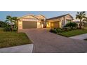 Two-story home with a three-car garage and brick driveway at 8437 Cane Bay Ct, Lakewood Ranch, FL 34202