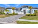 Stunning two-story home with a paver driveway and palm trees at 8544 Pavia Way, Bradenton, FL 34202