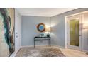 Condo entryway with contemporary decor, featuring a large artwork and a glass-top console table at 101 Benjamin Franklin Dr # 54, Sarasota, FL 34236