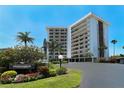 St Armands Towers South condo building exterior, featuring landscaping and private residence signage at 101 Benjamin Franklin Dr # 54, Sarasota, FL 34236