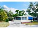 This single-story home features cream siding, a red brick foundation and a screened in porch for breezy evenings at 103 Oakwood Blvd, Sarasota, FL 34237