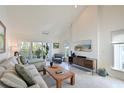 Bright living room with high ceilings, comfortable seating, and access to a private balcony at 114 Tidy Island Blvd, Bradenton, FL 34210
