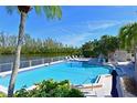 Gorgeous community pool area with lounge chairs, lush landscaping, and scenic waterfront views at 114 Tidy Island Blvd, Bradenton, FL 34210