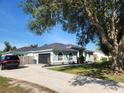 Well-kept single-story home with a two-car garage, featuring an inviting exterior, and landscaping at 13634 7Th Avenue Ne Cir, Bradenton, FL 34212