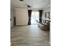 Bright living room with hardwood floors and sliding glass doors that lead to the pool at 13634 7Th Avenue Ne Cir, Bradenton, FL 34212