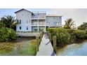 Private backyard with a wooden dock leading to the water at 2516 Avenue A, Bradenton Beach, FL 34217