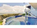 Inviting infinity pool and spa overlooking the water at 2516 Avenue A, Bradenton Beach, FL 34217
