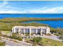 Aerial view of condo with waterway views, showing parking and location at 4540 Gulf Of Mexico Dr # 204, Longboat Key, FL 34228