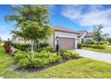 One-story home with tile roof, two-car garage, and manicured landscaping at 4735 Motta Ct, Bradenton, FL 34211