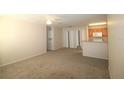 Spacious living room with carpet and kitchen access at 4850 51St W St # 8104, Bradenton, FL 34210