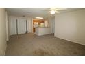 Living room with carpet and kitchen access at 4850 51St W St # 8104, Bradenton, FL 34210