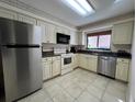 Bright kitchen boasts stainless steel appliances and granite countertops at 5171 Willow Links # 23, Sarasota, FL 34235