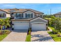 Two-story house with two-car garage, and nicely landscaped lawn at 6035 Worsham Ln # 104, Lakewood Ranch, FL 34211