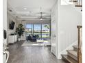 Foyer view into living room with wood-look tile floor and view of the lake at 6227 Anise Dr, Sarasota, FL 34238