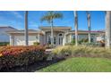 Well-maintained house with a landscaped yard and palm trees at 8956 Huntington Pointe Dr, Sarasota, FL 34238