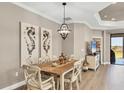 Dining area with a stylish table, chandelier, and views of the outdoors at 11265 Mc Dermott Ct, Englewood, FL 34223