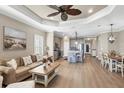 Open-concept living area with a comfortable seating area, dining space, and view of the kitchen at 11265 Mc Dermott Ct, Englewood, FL 34223