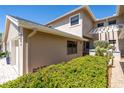 Side view of the townhome showcasing the exterior details and landscaping at 1720 Starling Dr # 103, Sarasota, FL 34231