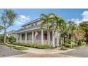 Two-story home with gray siding, red door, and palm trees at 1775 Stapleton St, Sarasota, FL 34239