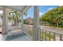 Relaxing covered porch offers a tranquil view of the street and lush greenery at 1775 Stapleton St, Sarasota, FL 34239