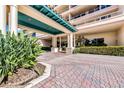 Elegant condo entrance with brick pavers and lush landscaping at 3070 Grand Bay Blvd # 612, Longboat Key, FL 34228