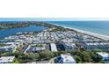 Wide aerial view of condo building and surrounding area at 3806 Gulf Of Mexico Dr # C-312, Longboat Key, FL 34228